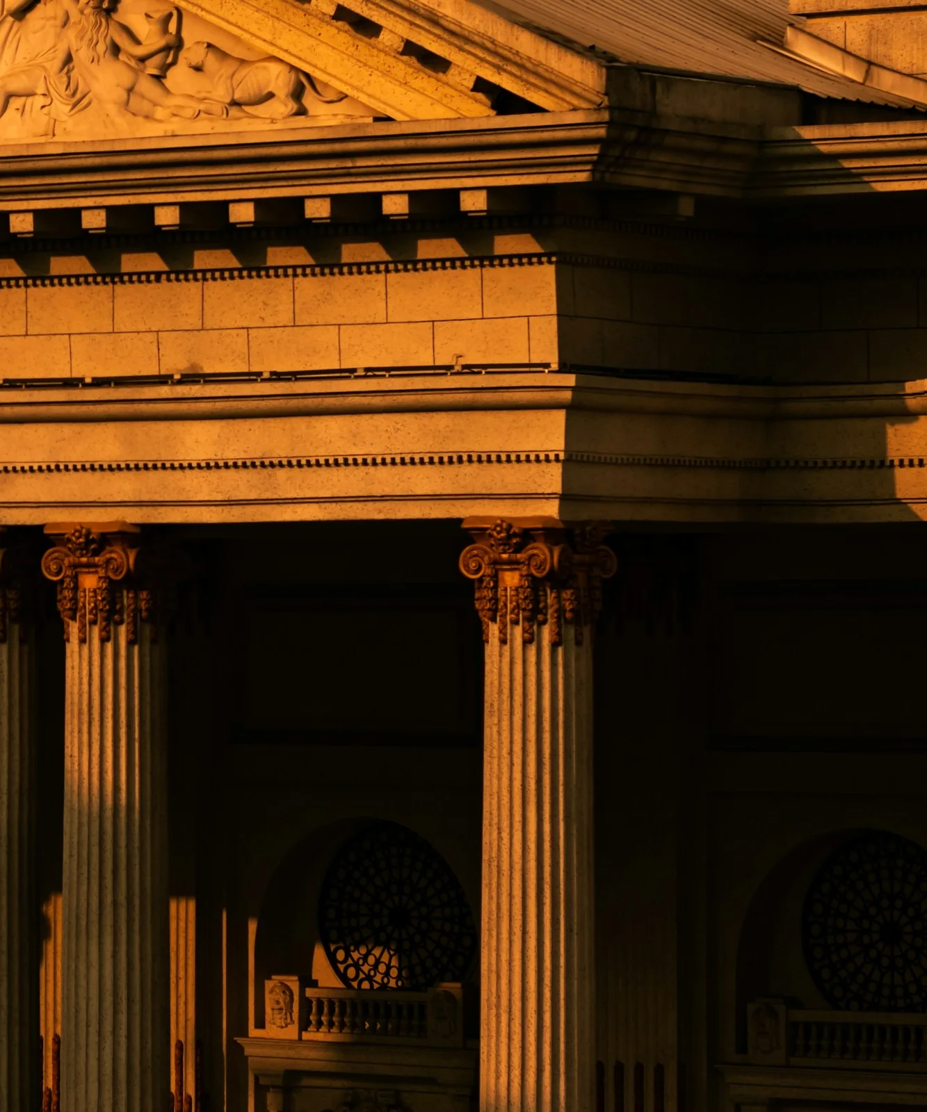 Warm sunlight and shadow across substantial stone columns